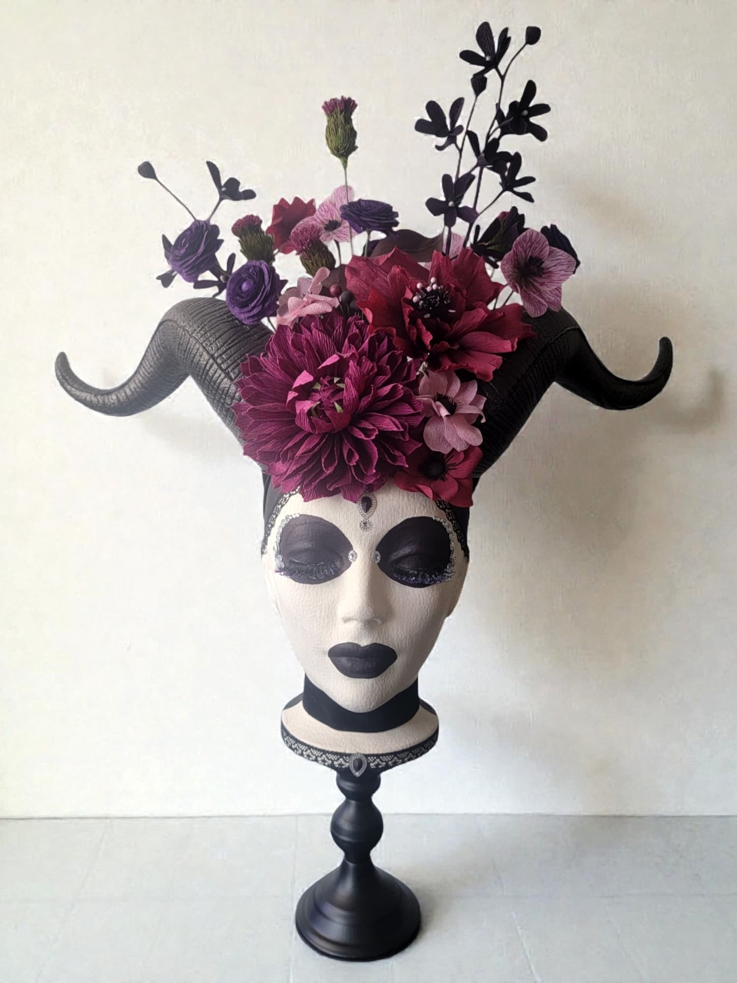Paper botanical sculpture with a crown of paper flowers